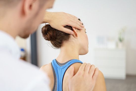 Physiotherapist stretching the injured neck Physiotherapist stretching the injured neck